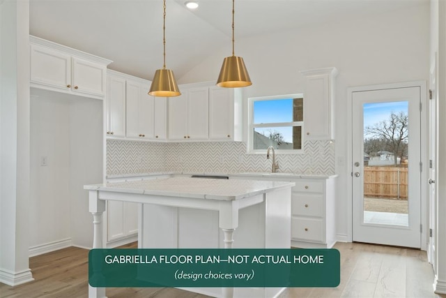 kitchen with a kitchen island, white cabinetry, hanging light fixtures, and tasteful backsplash