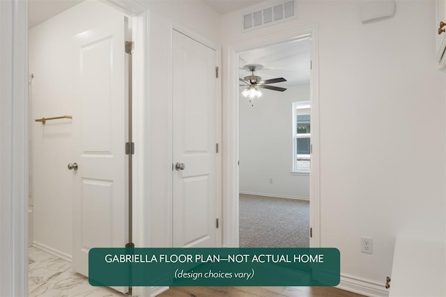 hallway featuring light colored carpet