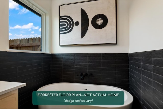 bathroom featuring a tub and tile walls