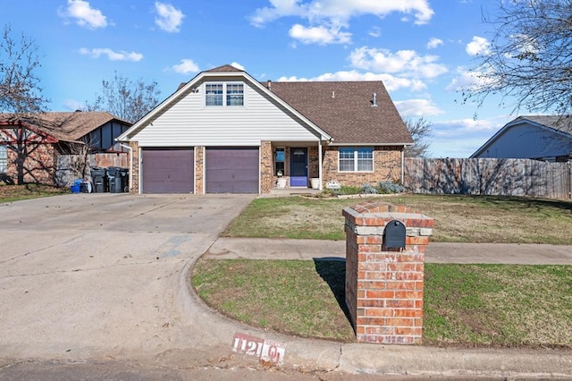 view of front of property with a garage and a front lawn