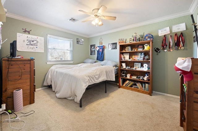 carpeted bedroom with ceiling fan and crown molding