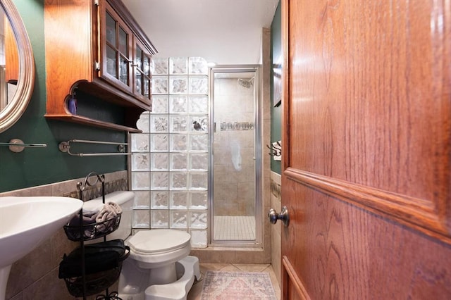 bathroom with tile patterned flooring, toilet, and walk in shower