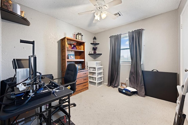 office area with ceiling fan and a textured ceiling