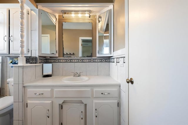 bathroom featuring decorative backsplash, toilet, and vanity