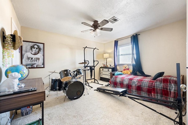 bedroom with carpet, ceiling fan, and a textured ceiling