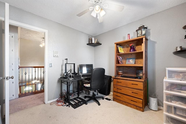 carpeted office space with ceiling fan and a textured ceiling