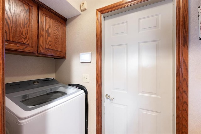 laundry room with cabinets and washer / dryer