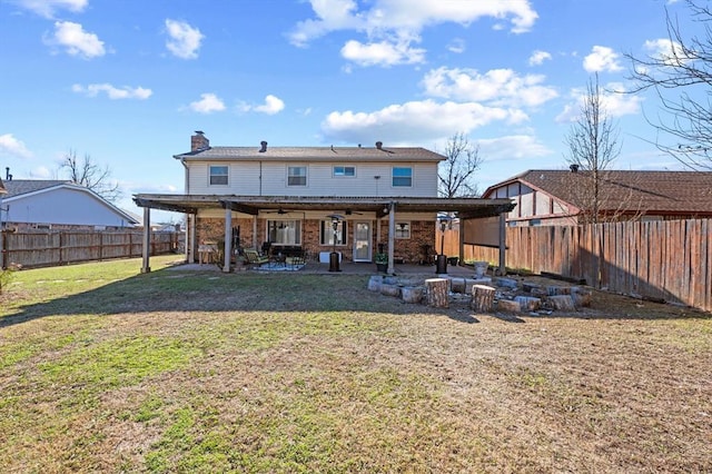 back of property featuring a lawn, ceiling fan, and a patio