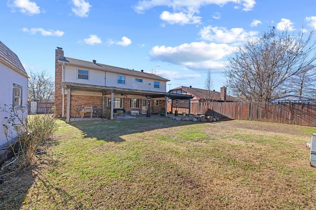 rear view of property with a lawn and a patio area