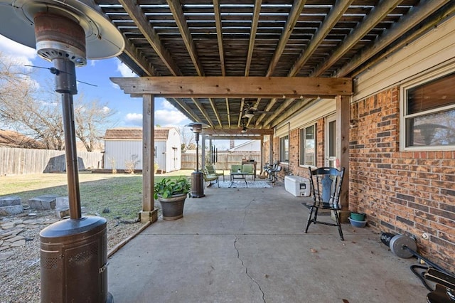 view of patio with ceiling fan and a shed