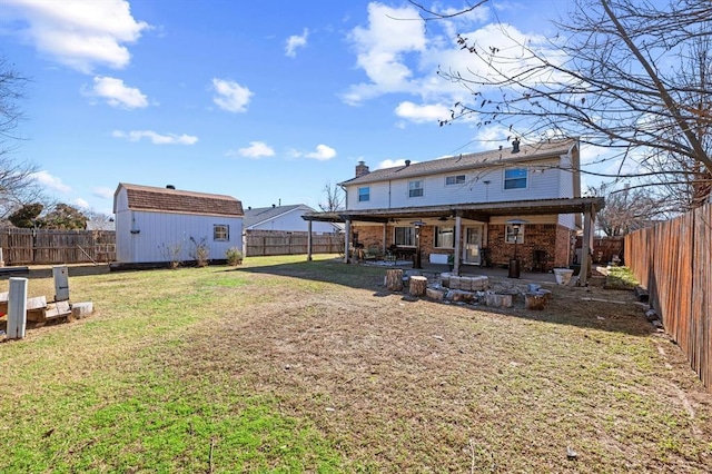 back of house featuring a patio, a storage shed, and a lawn