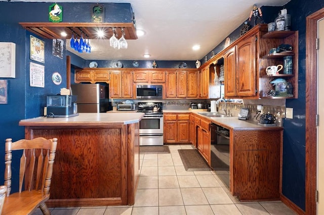 kitchen featuring appliances with stainless steel finishes, tasteful backsplash, light tile patterned floors, and sink