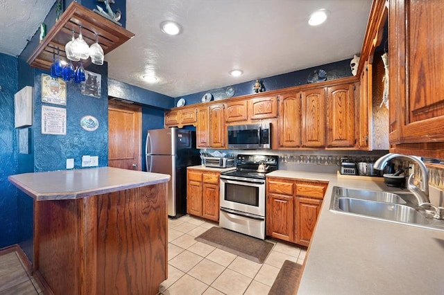 kitchen with backsplash, sink, hanging light fixtures, light tile patterned flooring, and stainless steel appliances