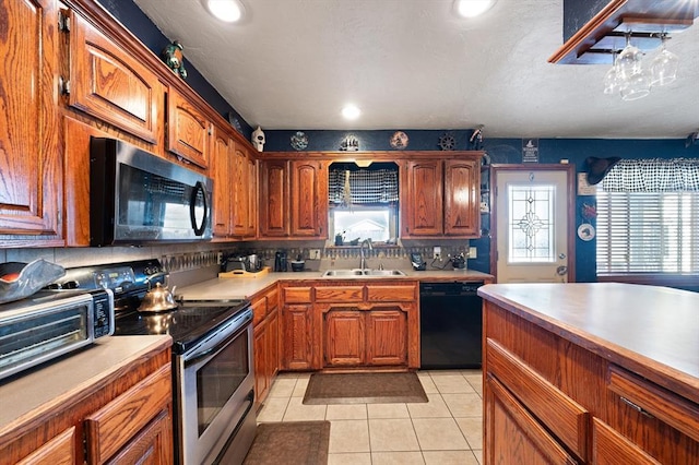 kitchen with dishwasher, backsplash, stainless steel electric stove, sink, and light tile patterned floors