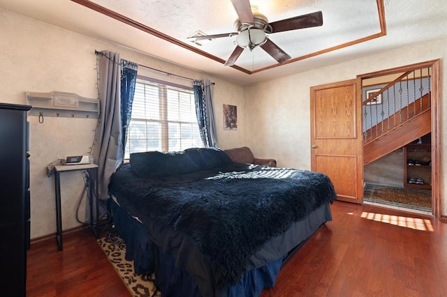 bedroom featuring ceiling fan and dark hardwood / wood-style flooring