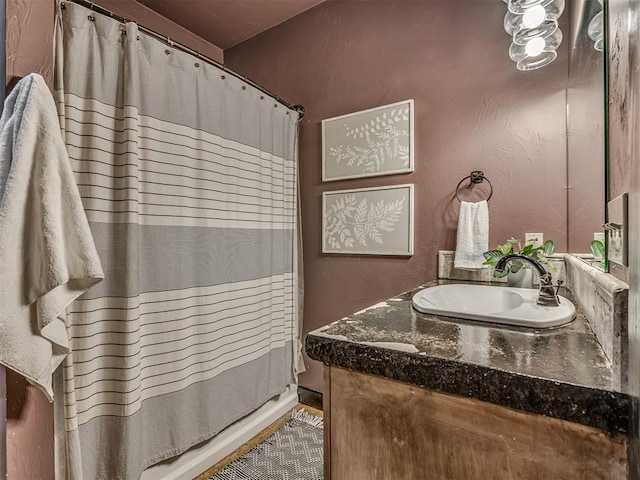 bathroom featuring vanity and a shower with shower curtain