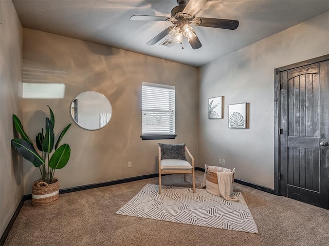 sitting room featuring light carpet and ceiling fan