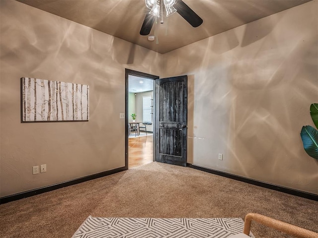 empty room with ceiling fan and light colored carpet