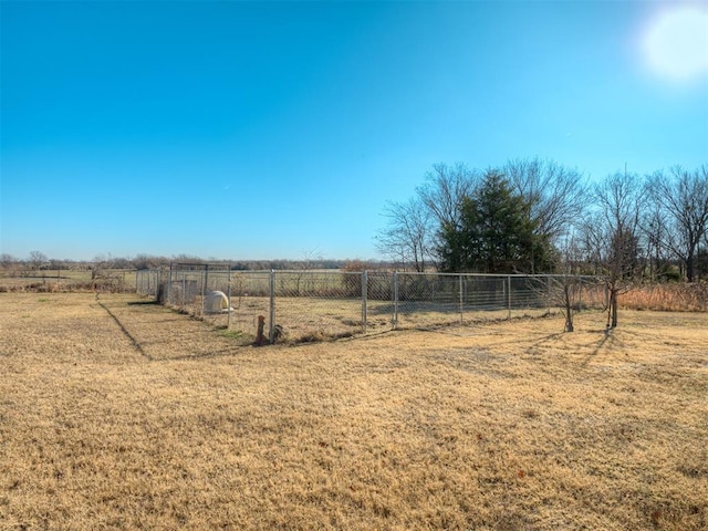 view of yard with a rural view and fence