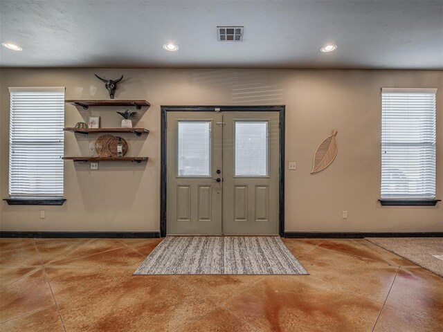 foyer entrance featuring baseboards, recessed lighting, visible vents, and a healthy amount of sunlight