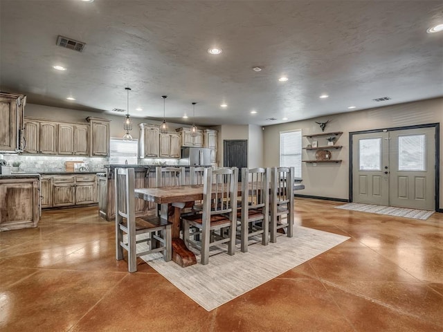 dining space featuring finished concrete flooring, visible vents, and recessed lighting