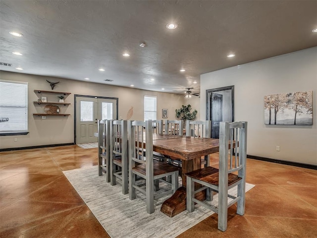 dining room featuring concrete floors, baseboards, and recessed lighting