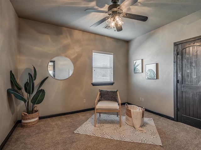 living area with carpet, visible vents, ceiling fan, and baseboards