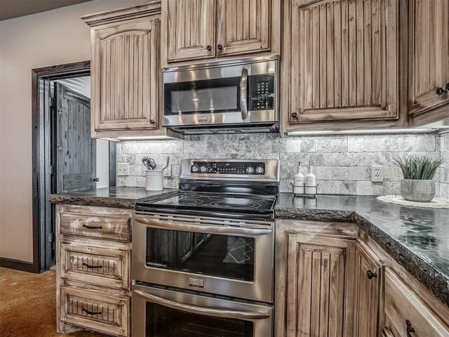 kitchen with stainless steel appliances and backsplash