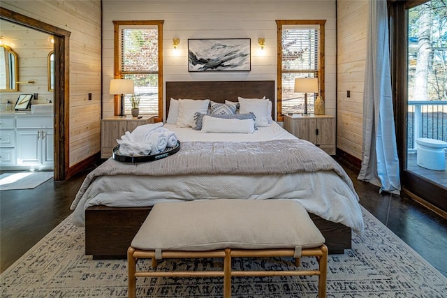 bedroom featuring wood walls and multiple windows