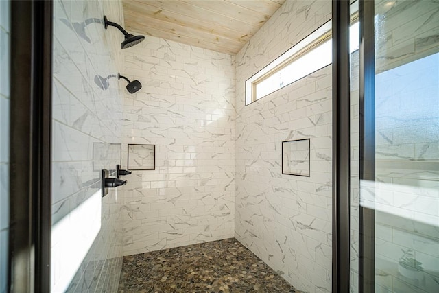 bathroom with wood ceiling and tiled shower