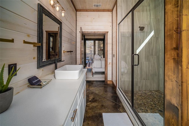 bathroom with an enclosed shower, wood ceiling, wooden walls, and concrete floors