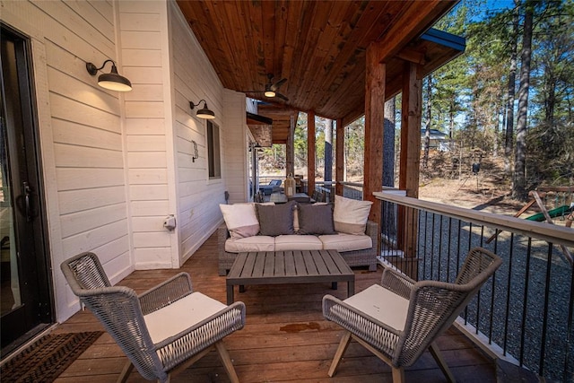 wooden terrace with an outdoor living space