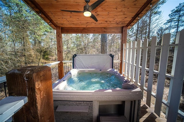 wooden deck with ceiling fan and a hot tub