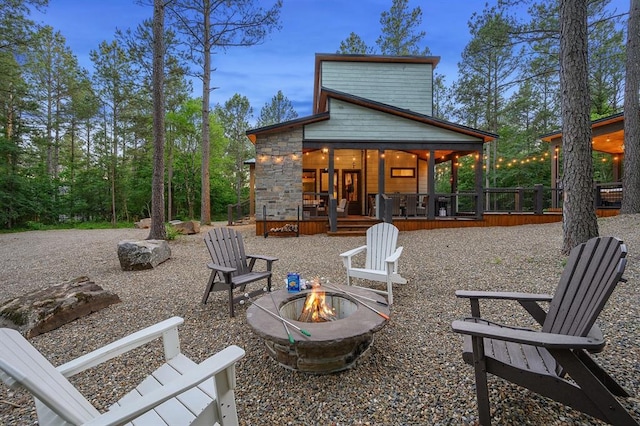 view of patio featuring a fire pit and a deck