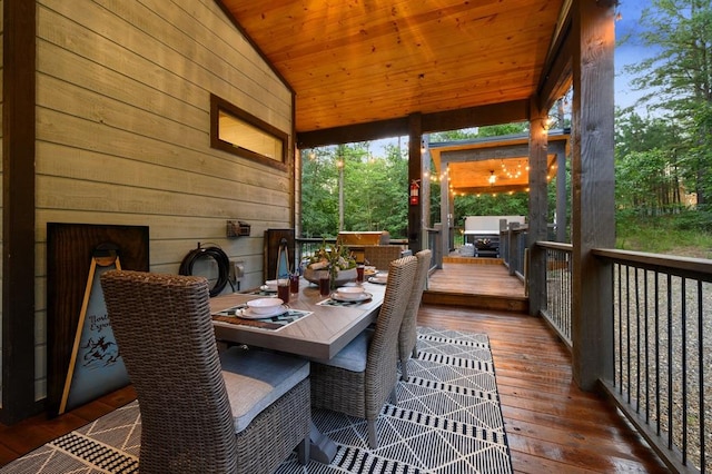 sunroom featuring wood ceiling and vaulted ceiling