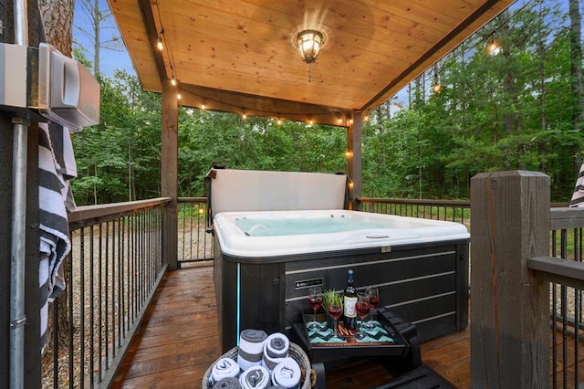 wooden terrace featuring a hot tub