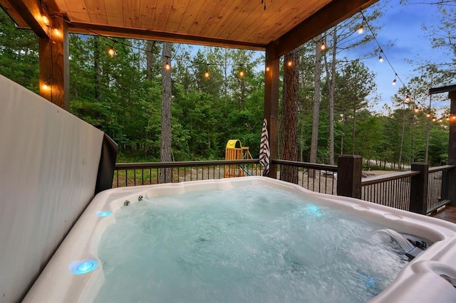 view of swimming pool with a hot tub