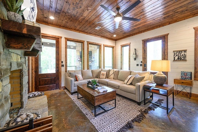 tiled living room with ceiling fan, wood ceiling, and wood walls