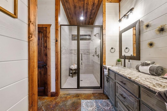 bathroom with wooden walls, vanity, wood ceiling, and walk in shower