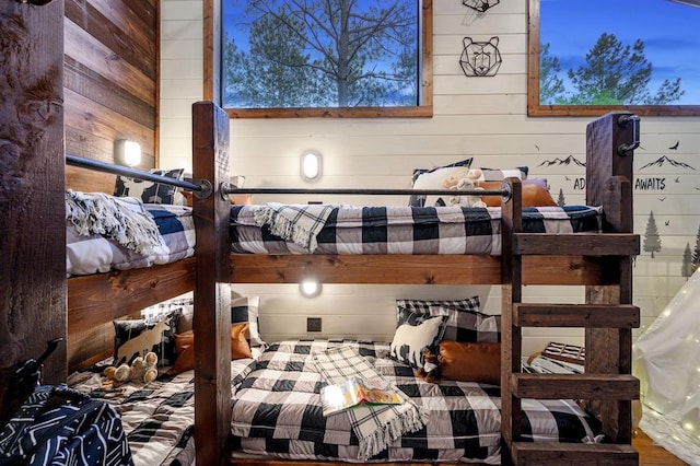 bedroom with wood walls