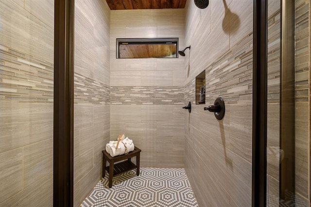 bathroom with a tile shower and wooden ceiling