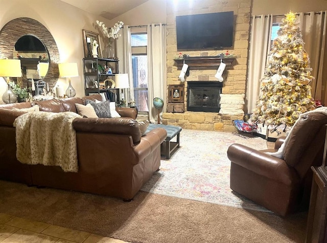 tiled living room with a stone fireplace and vaulted ceiling