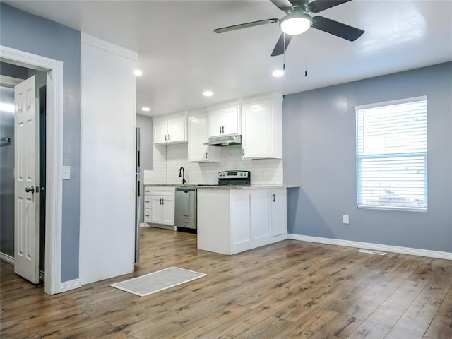 kitchen with white cabinetry, hardwood / wood-style floors, tasteful backsplash, and appliances with stainless steel finishes