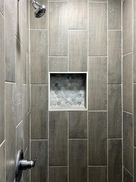 room details with a tile shower