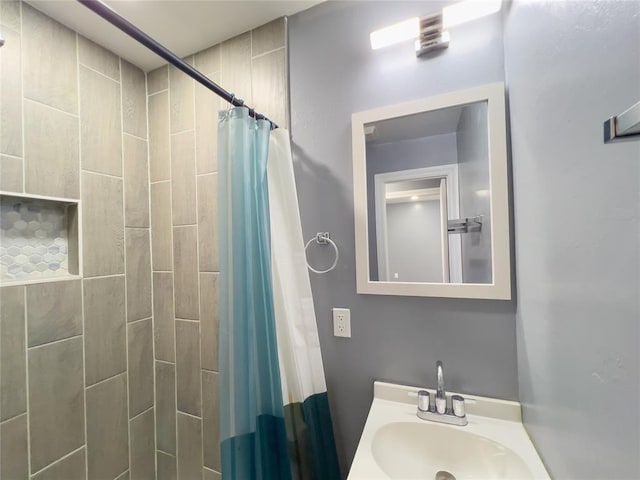 bathroom with sink and a shower with shower curtain