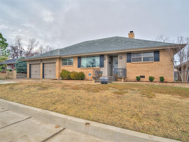 view of front of home with a front lawn and a garage