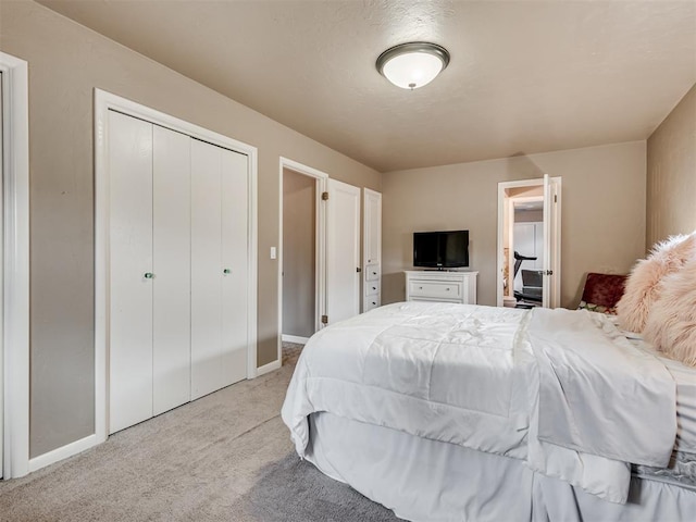 bedroom featuring light colored carpet and a closet