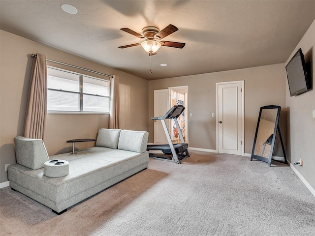 sitting room featuring light carpet and ceiling fan