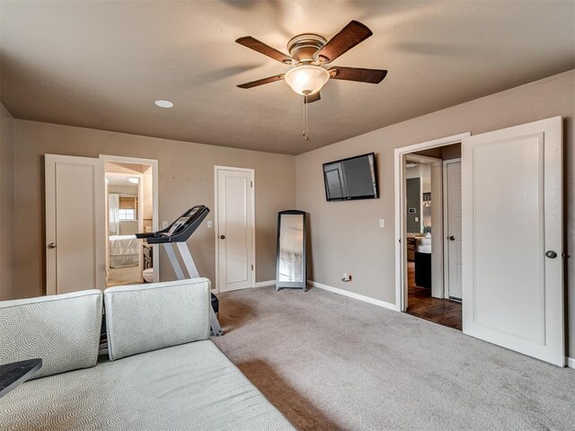 workout room with carpet and ceiling fan