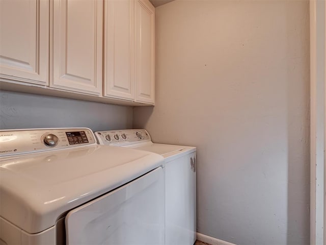 washroom with washer and clothes dryer and cabinets